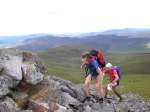 A team reach the cairn, control 154, after a stiff climb