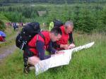 Competitors marking up their map after the start