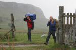 Mike James and Les Hunt carry heavy loads into the camping field