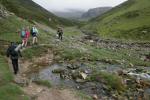 C course competitors pass a river emerging from a spring