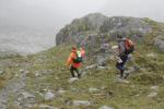 Poles help a couple balance on the slippery ground