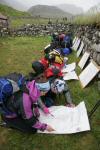 Some found shelter behind a stone wall for marking up their maps