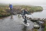 One of the older teams cross the outflow of Loch Fleodach Coire