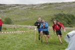 Two Elite teams race down the finish funnel (see next photo)