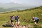 Jon Brooke photographs a team climbing to their first control (with Loch Tulla in the background)