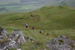 Teams descending west side of knoll to the penultimate control on the A and D courses