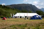 Event centre marquee stands beside tree-lined River Finnan